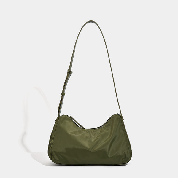 Soft crescent shoulder bag in smooth sheen nylon with contrast leather-look trim, slim adjustable strap, and top zip closure
