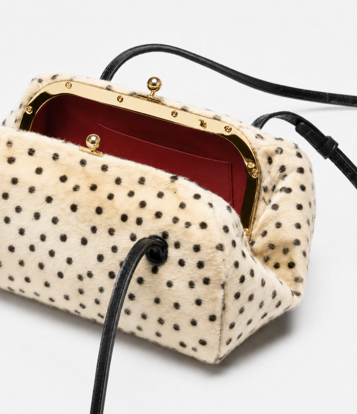 Spotted faux-fur barrel shoulder bag with gold kiss-lock clasp and black adjustable leather-look straps, detail view 12