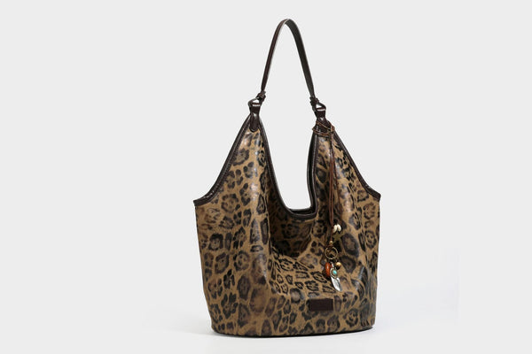 Large slouchy leopard-print shoulder tote bag with glossy tan-and-brown finish, dark brown leather-look trim, single