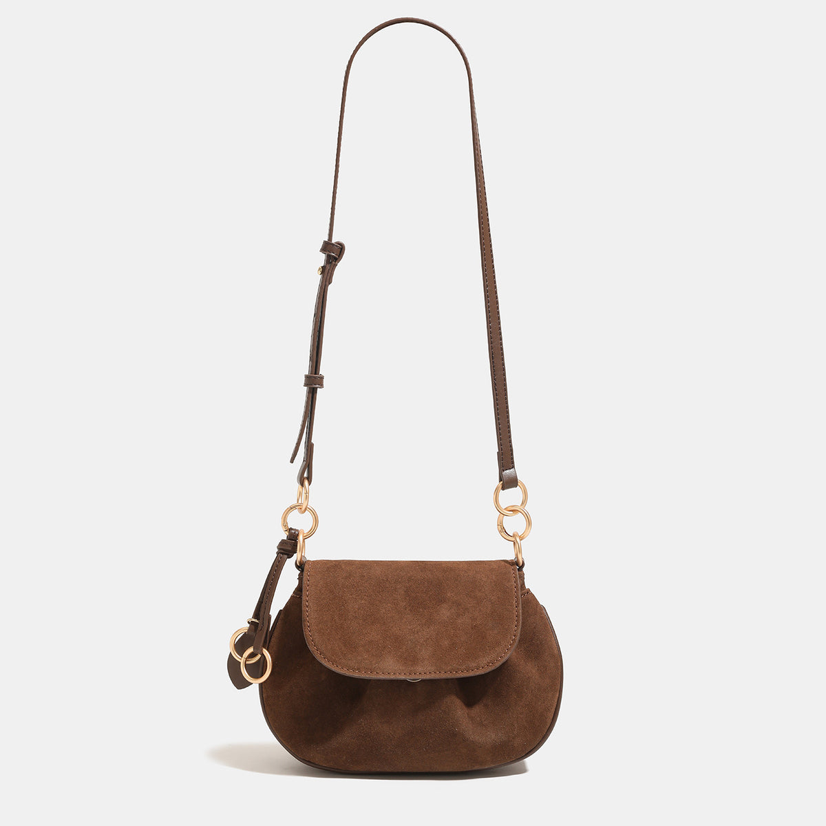 Small rounded flap crossbody saddle bag with gold-tone ring hardware and adjustable strap, detail view 7