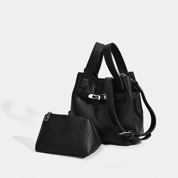 Small structured pebbled leather-look bucket bag with silver turn-lock bar hardware and dual top handles, detail view 3