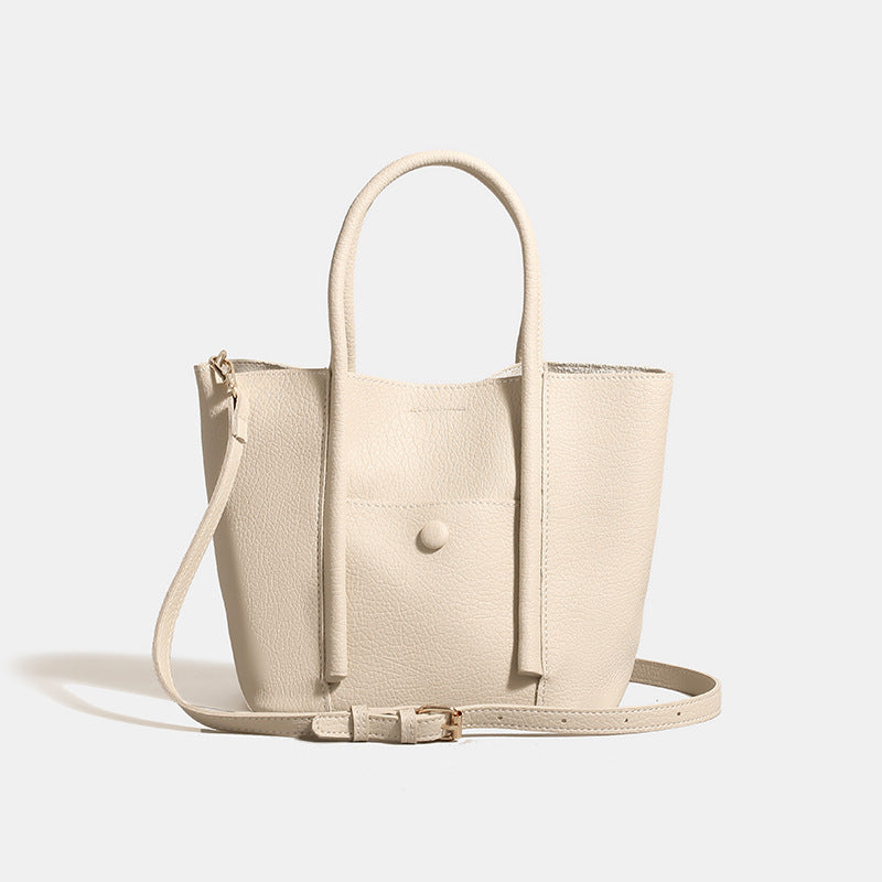 Structured pebbled matte tote bag with front snap pocket, dual top handles, and detachable zip pouch in almond beige, detail
