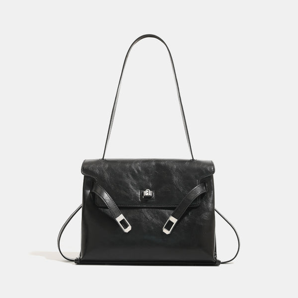 Structured rectangular flap shoulder bag in glossy leather-look finish with silver turn-lock clasp and adjustable strap