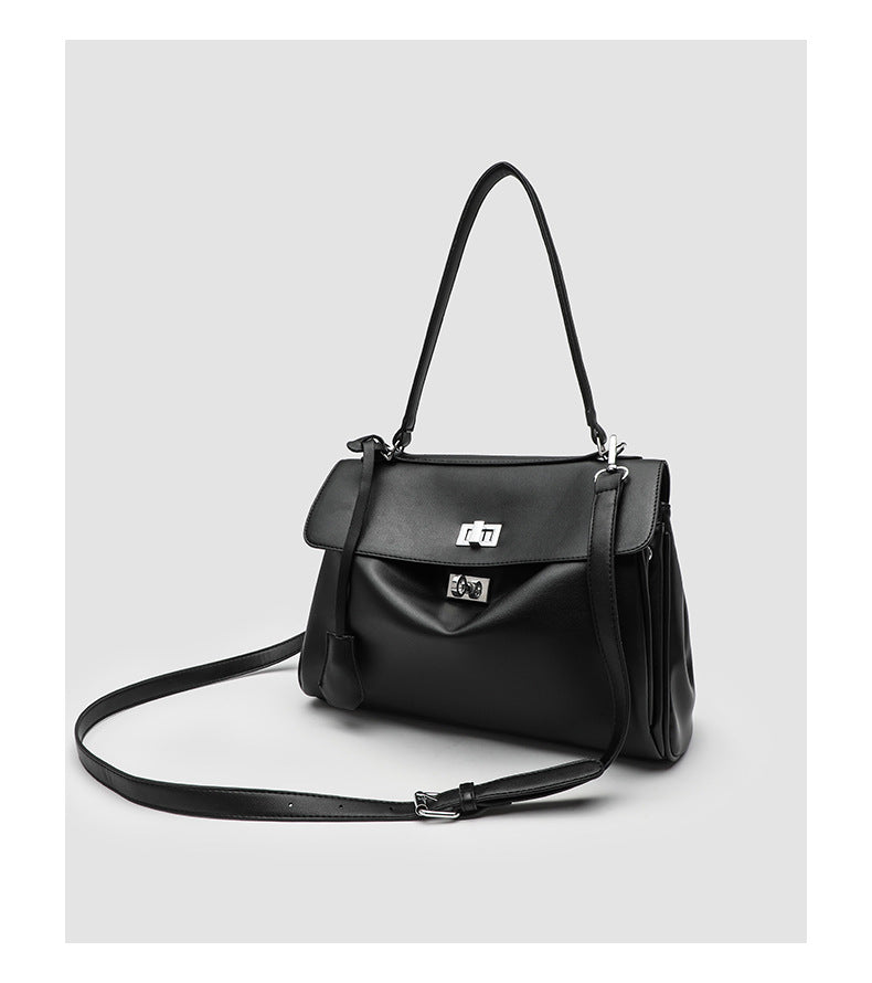 Structured black leather-look flap satchel bag with silver turn-lock hardware and top handle, detail view 16