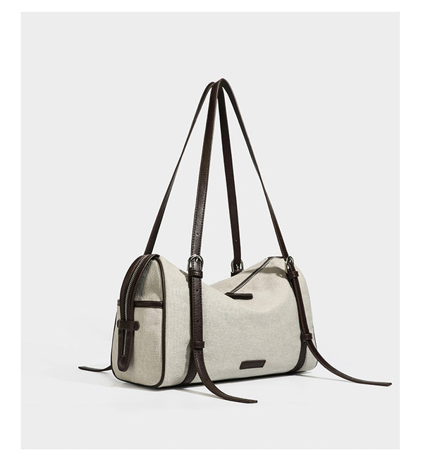 Cream canvas barrel shoulder bag with dark brown leather-look straps, trim, and silver-tone hardware, detail view 9