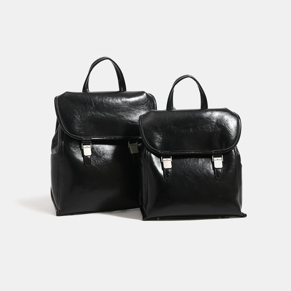 Structured glossy leather-look flap backpack with twin buckle closures and top grab handle, detail view 3