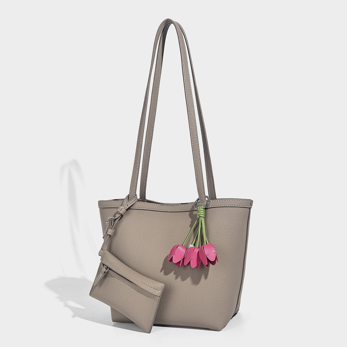 Structured pebbled leather-look tote bag in taupe with long shoulder strap, detachable zip pouch, and pink tulip flower