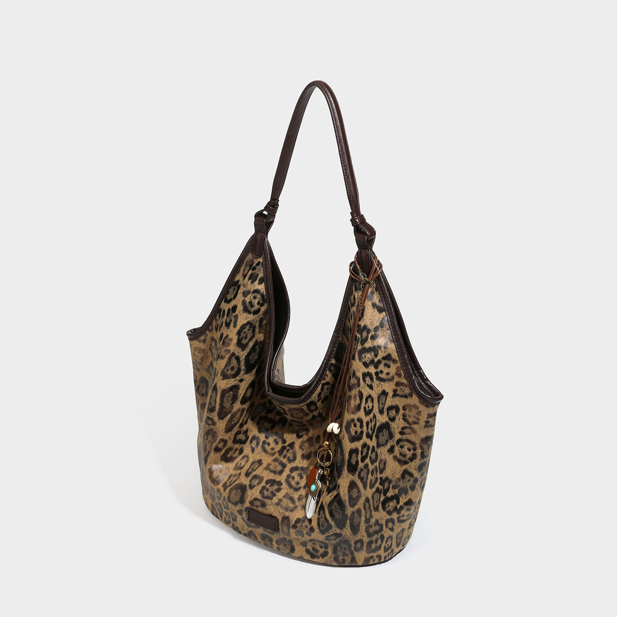 Large slouchy leopard-print shoulder tote bag with glossy tan-and-brown finish, dark brown leather-look trim, single