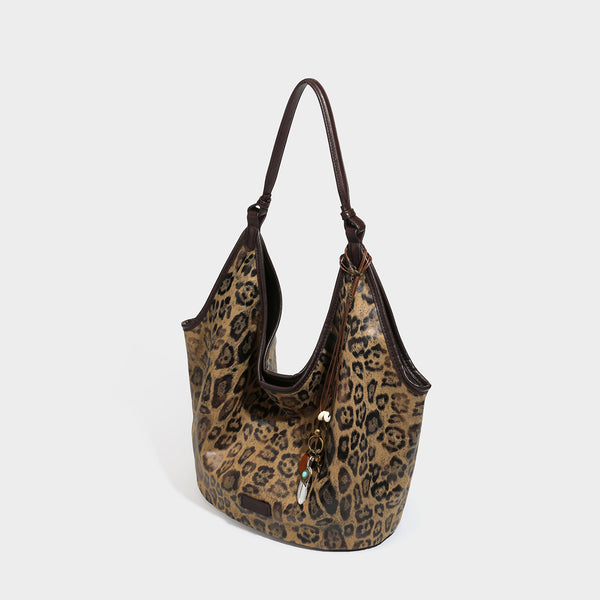 Large slouchy leopard-print shoulder tote bag with glossy tan-and-brown finish, dark brown leather-look trim, single