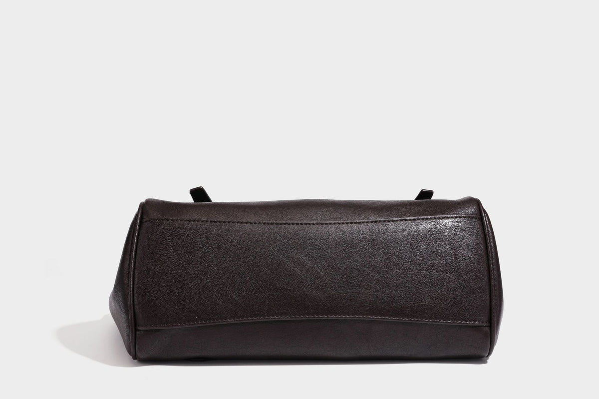 Large structured vintage-style tote bag with flap-front turn-lock closure, twin buckle straps, and double shoulder handles