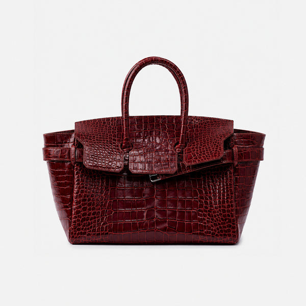 Large structured tote satchel with glossy crocodile-embossed leather-look finish, dual top handles, and metal buckle flap
