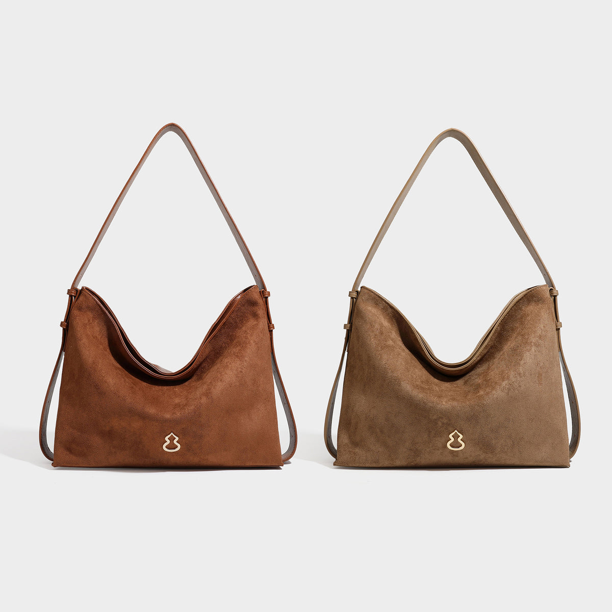 Slouchy suede-finish brown shoulder bag with long single strap and small gold-tone logo emblem on front, detail view 48