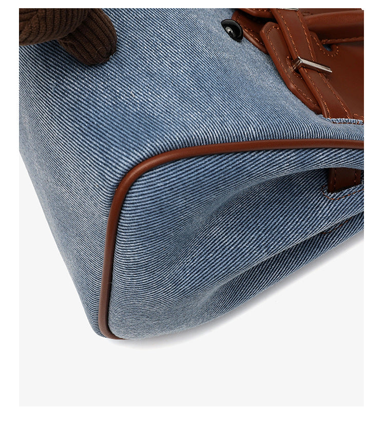 Small structured trapezoid satchel bag with smiling face motif, pom-pom accents, brown leather-look trim, silver-tone, detail