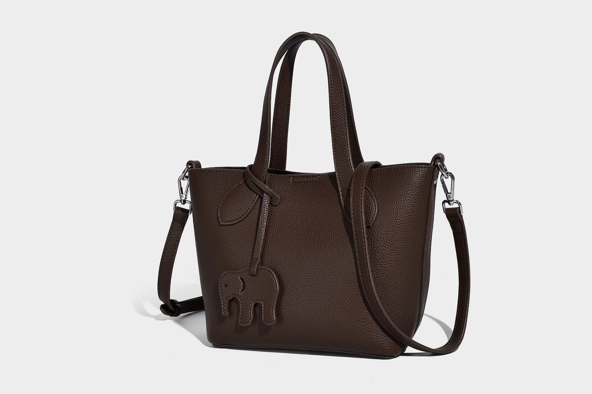 Compact pebbled bucket tote bag with elephant charm, twin top handles, and detachable crossbody strap, detail view 31