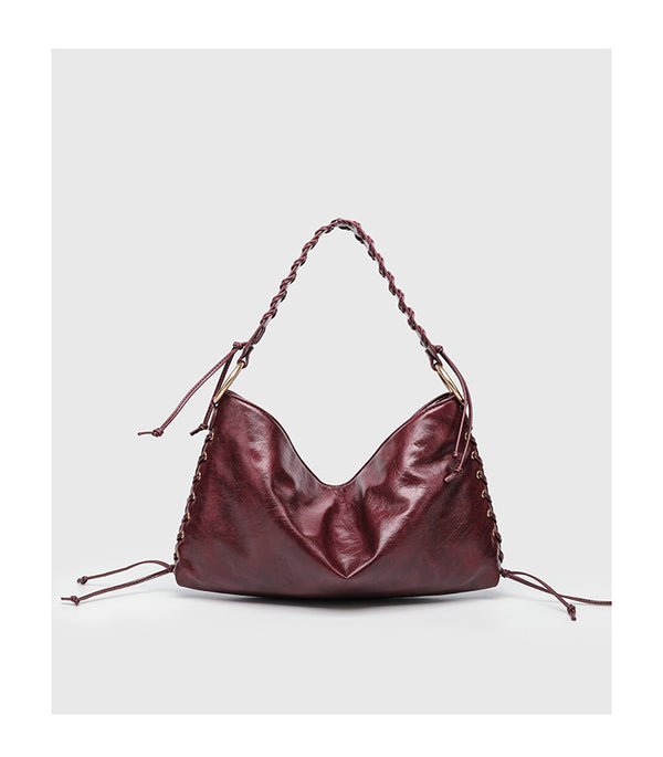 Large slouchy hobo shoulder bag with braided top handle, gold-tone O-ring hardware, and lace-up side cord detailing in