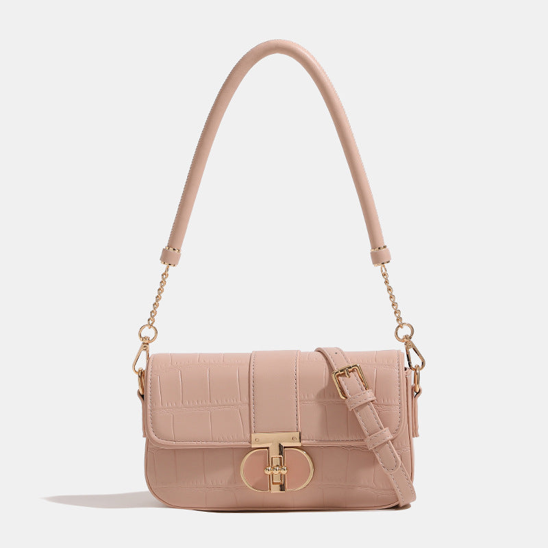 Small crocodile-embossed flap crossbody bag with circular gold turn-lock closure and chain strap, front view