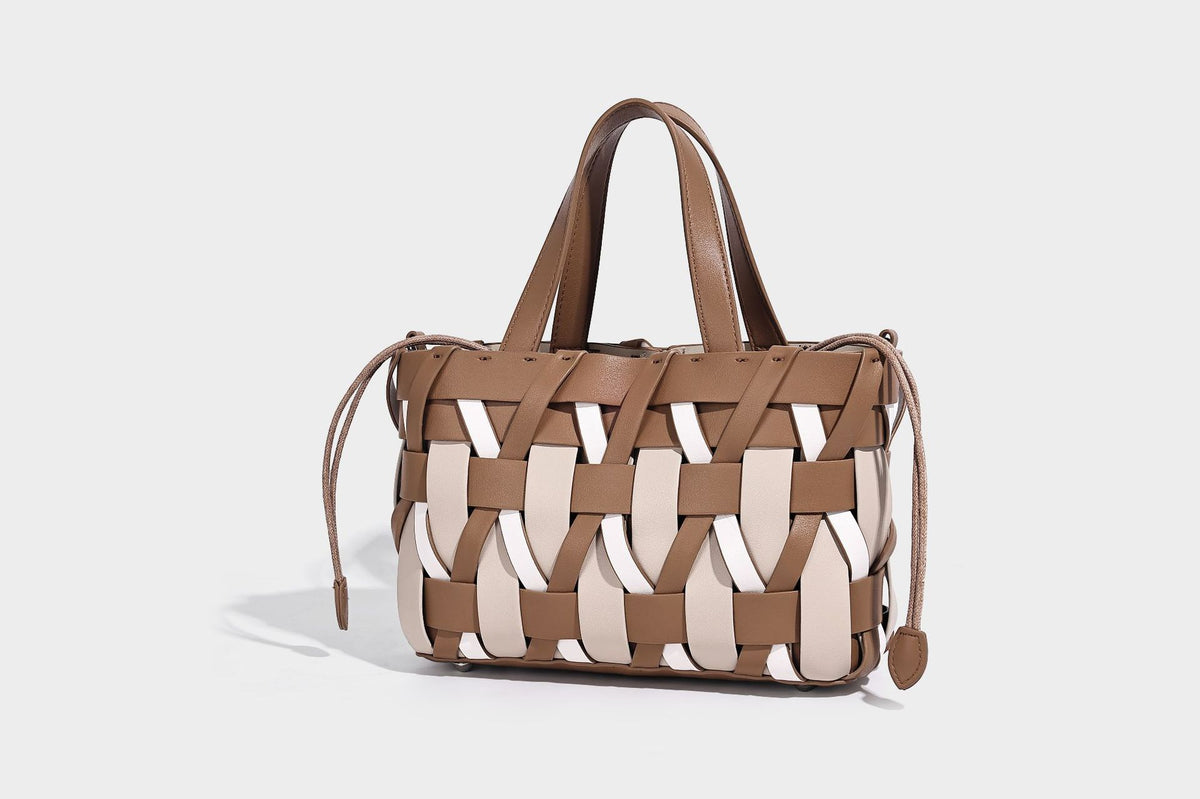 Small structured woven lattice tote bag with dual top handles and detachable shoulder strap in brown and cream leather-look