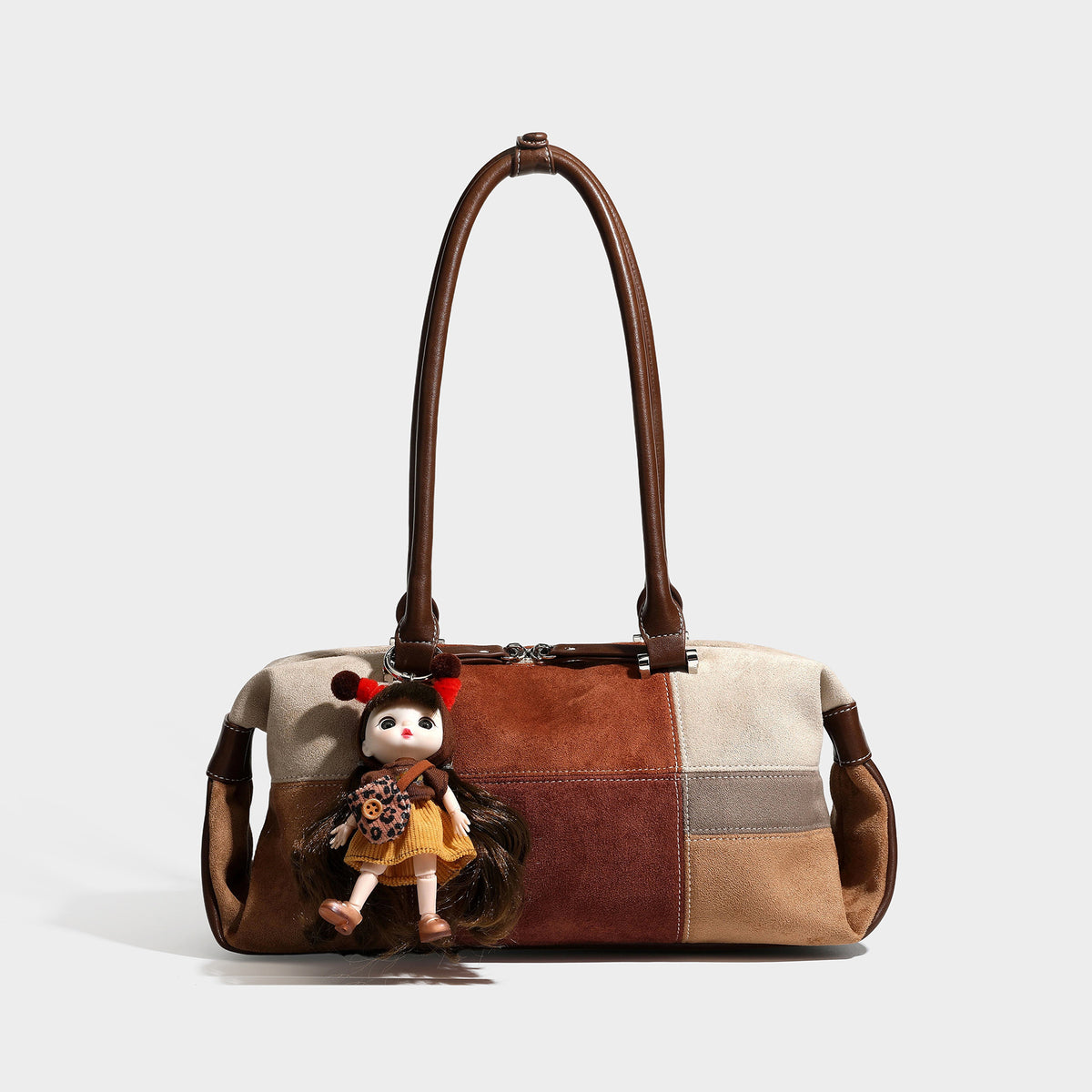 Patchwork suede-look barrel shoulder bag in brown, rust, tan, beige, and gray panels with double leather-look straps and