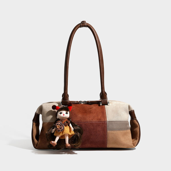 Patchwork suede-look barrel shoulder bag in brown, rust, tan, beige, and gray panels with double leather-look straps and