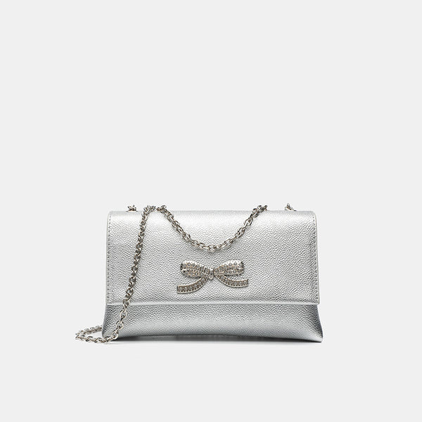 Structured rectangular flap crossbody bag with rhinestone bow and silver chain strap in pebbled finish, detail view 8