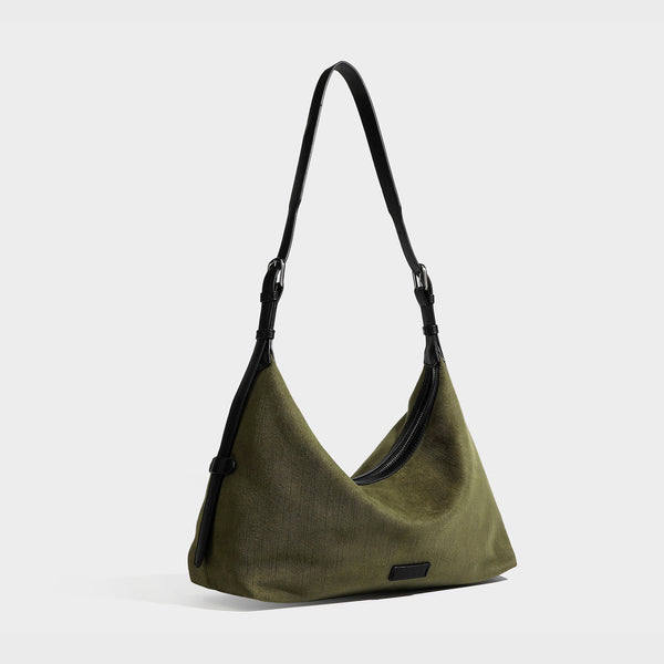 Slouchy olive green canvas hobo shoulder bag with black leather-look trim, zip-top closure, and adjustable strap, detail view