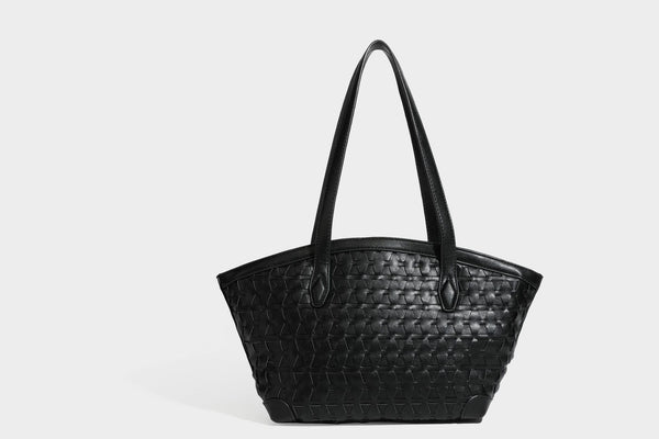 Large leather-look tote bag with geometric woven emboss, double shoulder straps, and round woven cord charm in brown, detail