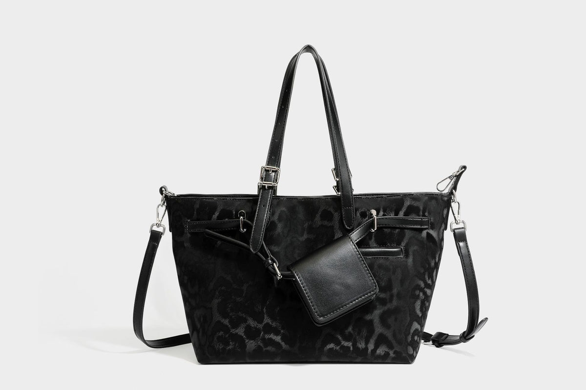 Glossy leopard-print tote bag with leather-look dark trim, dual top handles, detachable shoulder strap, and attached front