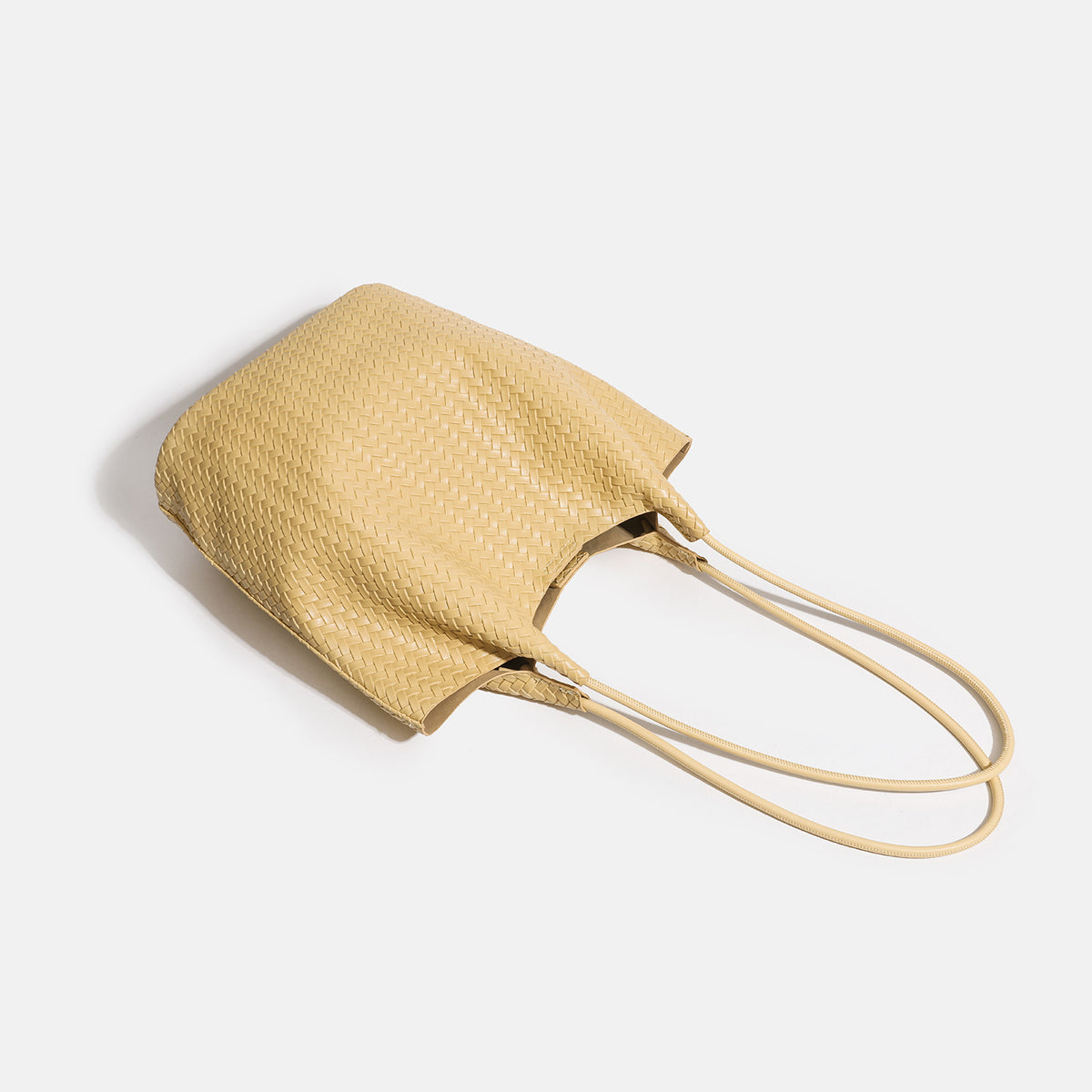 Large woven textured tote bag with long shoulder straps and structured rectangular base, detail view 4