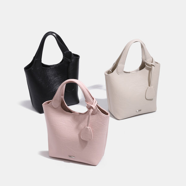 Soft glossy leather-look bucket tote bag with twin handles and detachable crossbody strap, detail view 2