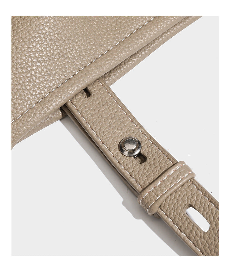 Pebbled leather-look tote bag with front toggle hardware and long shoulder strap, detail view 17