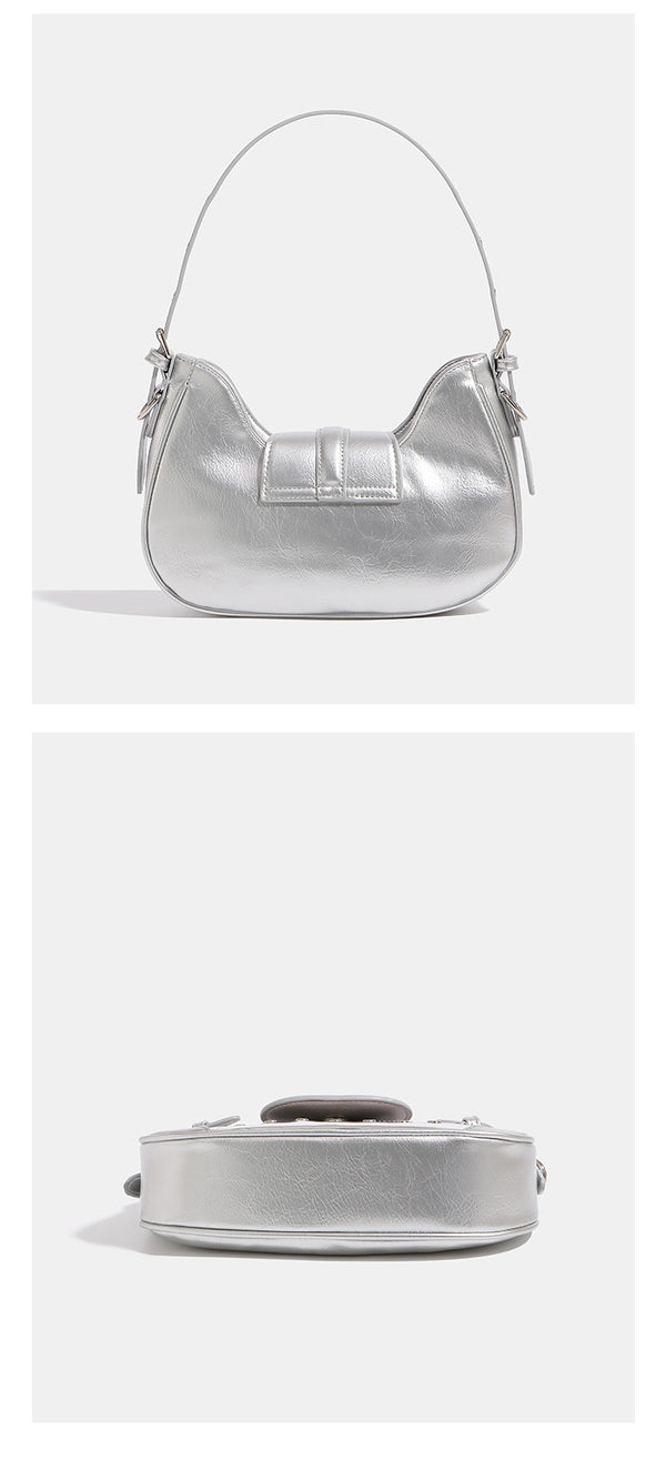 Compact croc-embossed leather-look shoulder bag with silver grommet trim, buckle strap detail, and four-point star turn-lock
