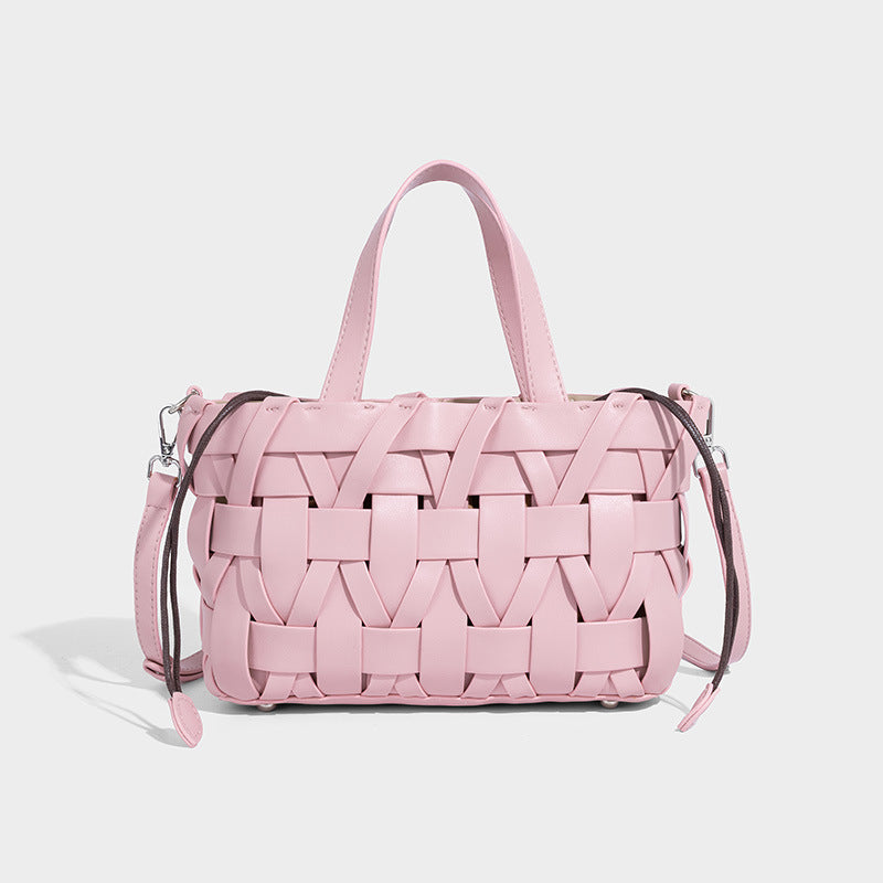 Structured woven basket tote handbag with contrasting dark trim, double top handles, detachable shoulder strap, and