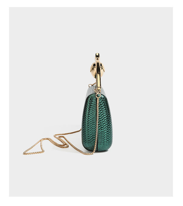 Structured rectangular metallic woven clutch bag with sculptural gold-tone leaf top handle and detachable chain strap, detail