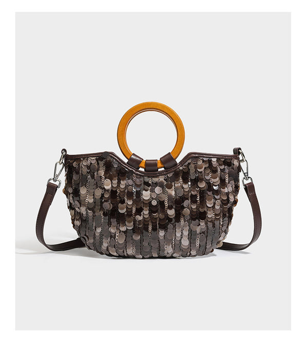 Small sequin half-moon handbag with circular wood-look ring handles and detachable leather-look shoulder strap, detail view