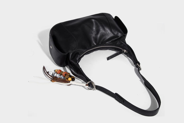 Soft pebbled leather-look hobo shoulder bag with zip top closure, side flap pockets, and silver-tone hardware, detail view 20