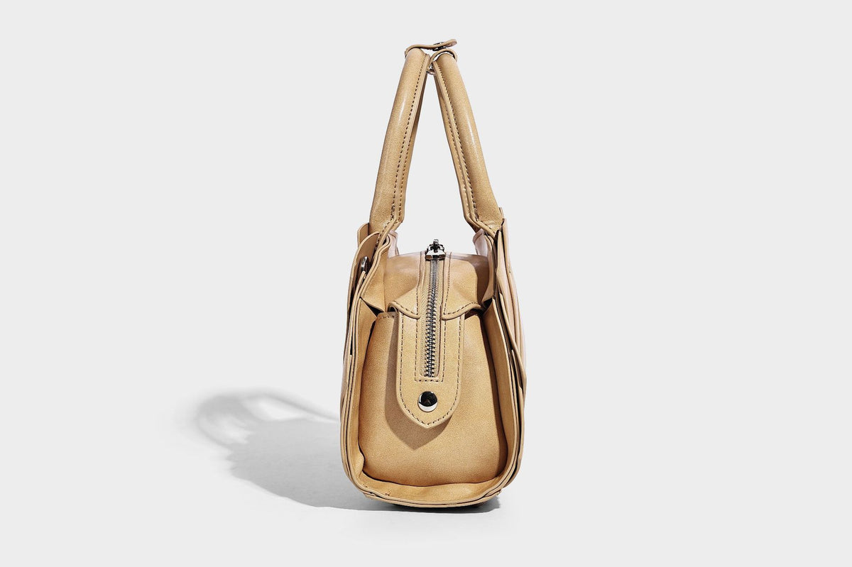 Structured dome satchel with fan-pleated leather-look exterior, dual top handles, and detachable shoulder strap, detail view