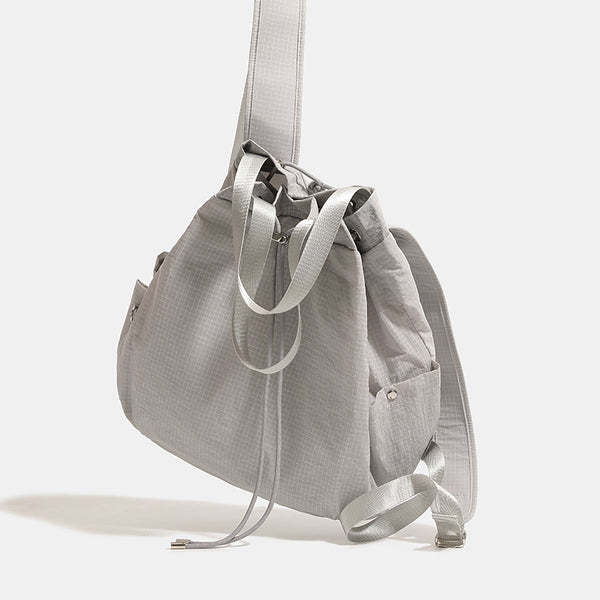 Glacier gray grid-texture nylon drawstring bucket convertible backpack with top handles and adjustable shoulder straps