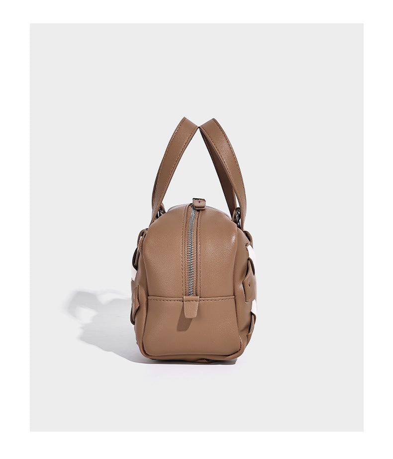 Small structured satchel bag with two-tone woven front panel, dual top handles, and detachable crossbody strap in tan brown