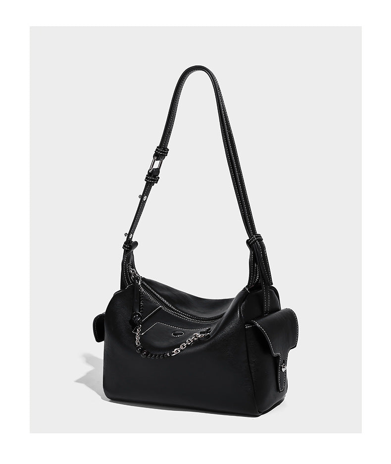 Small slouchy moto-style crossbody bag in smooth matte leather-look finish with white contrast stitching, silver-tone, detail