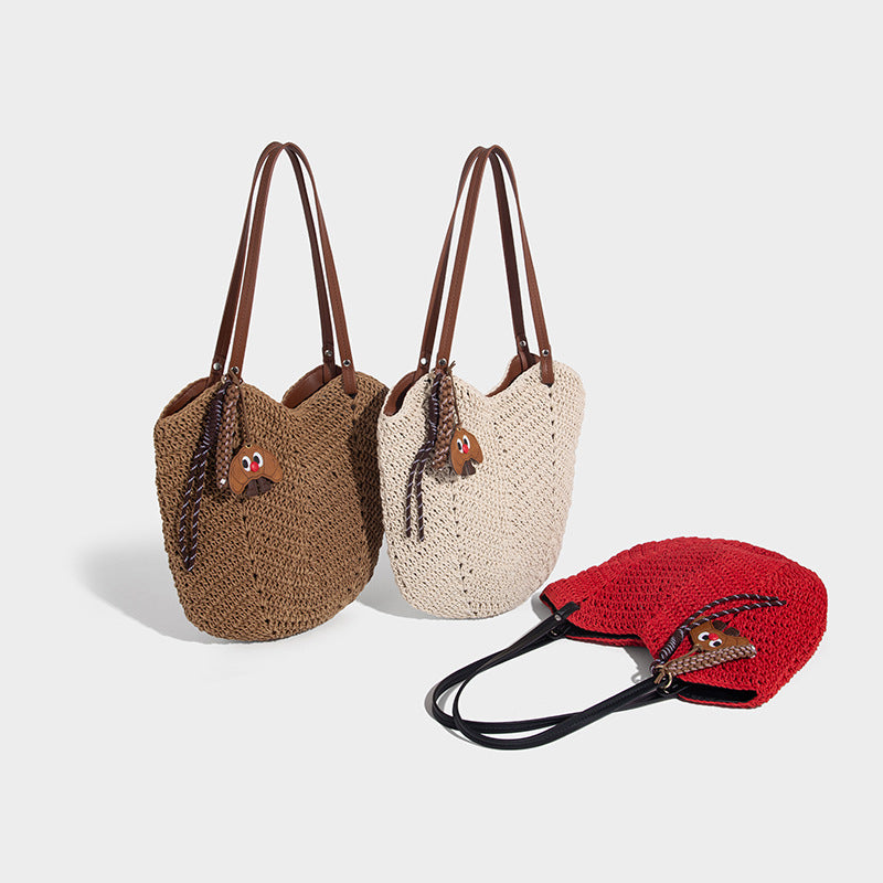 Woven crochet open-top shoulder tote bag with slim brown leather-look straps and braided charm accent, detail view 2