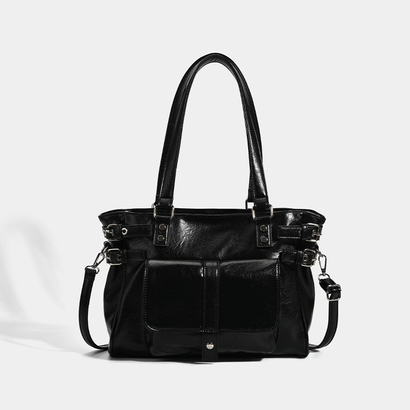 Large glossy leather-look tote bag with front flap pocket, silver-tone buckle hardware, dual top handles and detachable