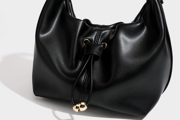 Slouchy hobo bag with smooth leather-look finish, drawstring cinch closure, and gold-tone bead hardware, detail view 28