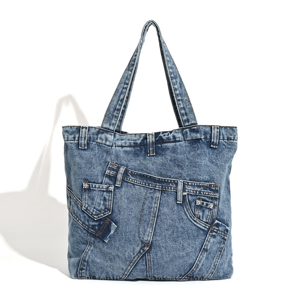 Large washed denim tote bag with jeans-style patch pocket and riveted seam detailing, double shoulder straps, open top