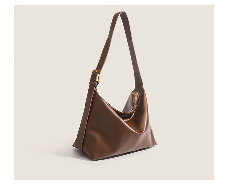 Large slouchy hobo shoulder bag in smooth leather-look finish with single long strap and gold-tone zip closure, detail view