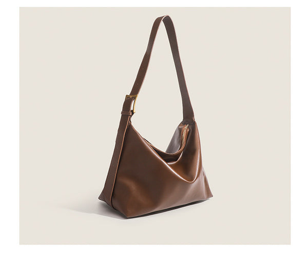 Large slouchy hobo shoulder bag in smooth leather-look finish with single long strap and gold-tone zip closure, detail view