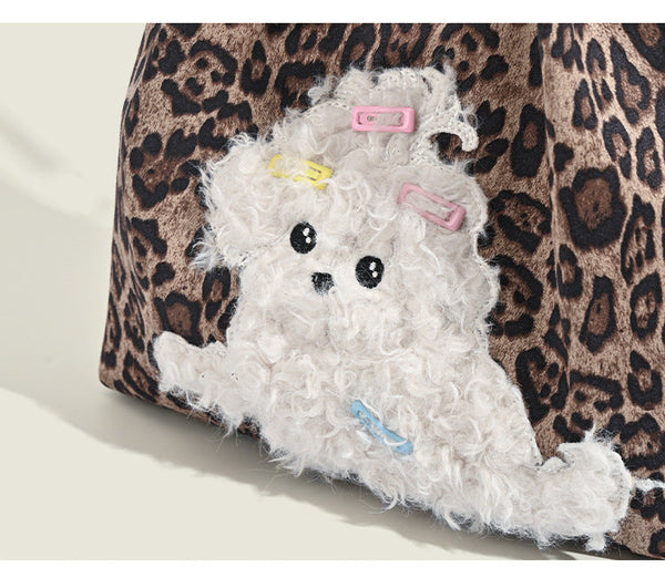 Leopard-print fabric tote bag with white plush teddy bear appliqué and brown leather-look shoulder straps, detail view 8