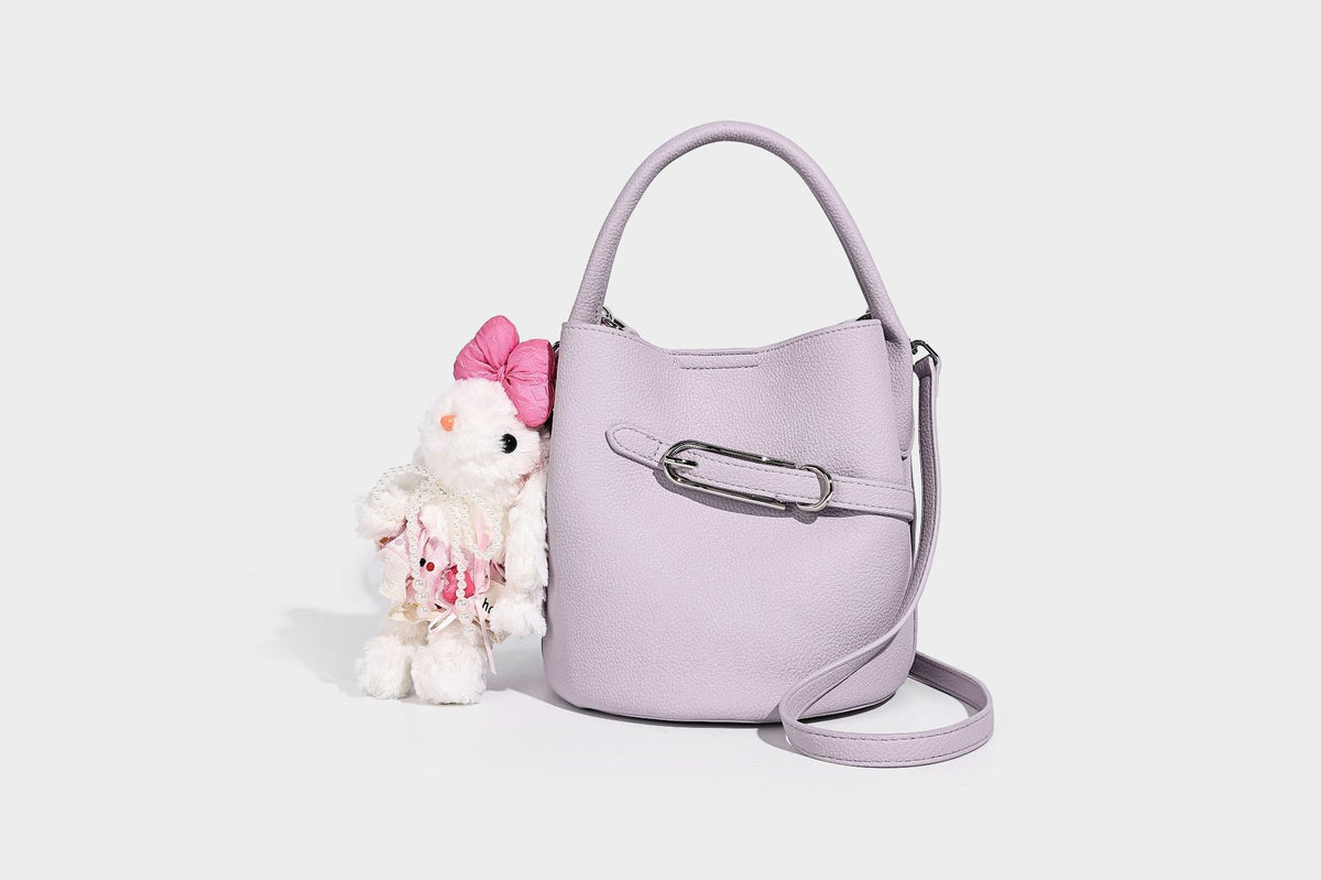 Mini pebbled leather-look bucket bag with front buckle strap, silver-tone hardware, top handle, and detachable shoulder