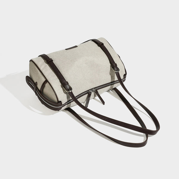 Cream canvas barrel shoulder bag with dark brown leather-look straps, trim, and silver-tone hardware, detail view 4