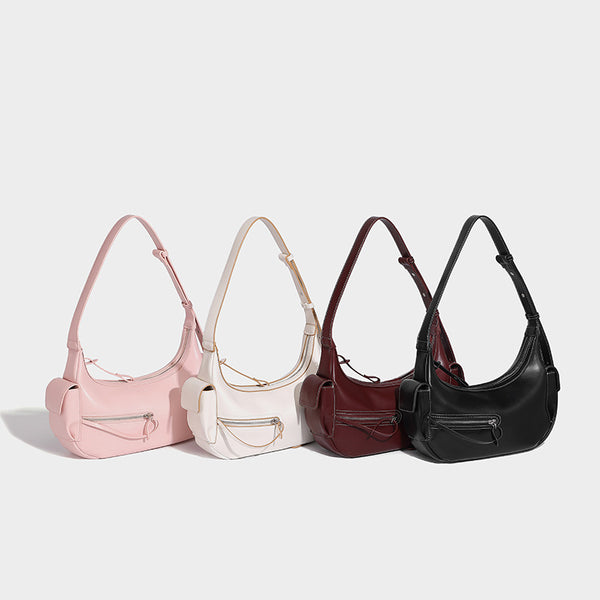 Smooth leather-look crescent shoulder bag with front zip pocket, side flap pockets, adjustable strap, and silver-tone, detail