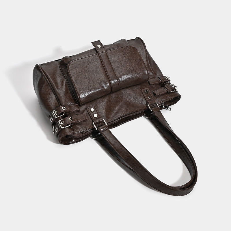 Large glossy leather-look tote bag with front flap pocket, silver-tone buckle hardware, dual top handles and detachable